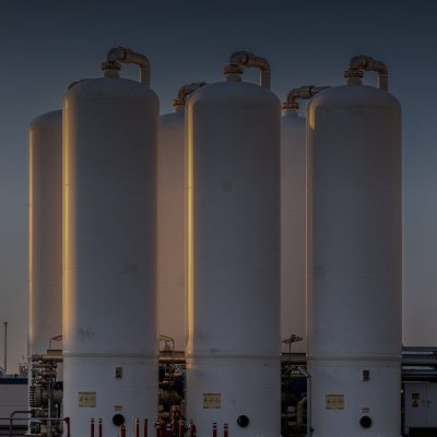 Industrial gas storage tanks at sunset